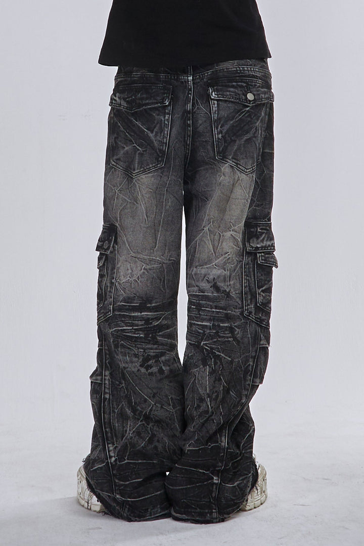 Black wide-leg cargo jeans with fractured textured finish and multiple utility pockets