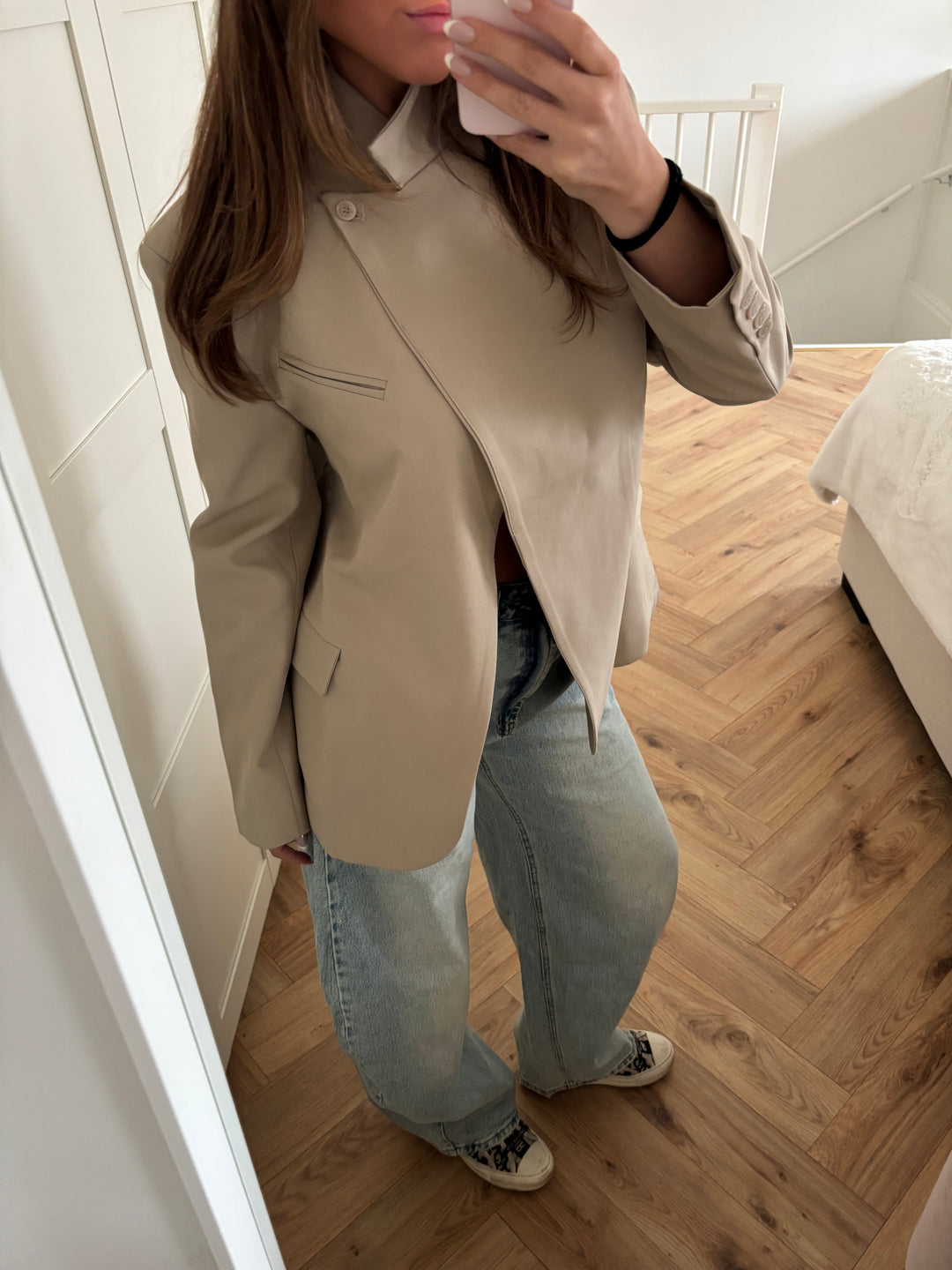 Women's beige blazer with high collar, long sleeves and button front