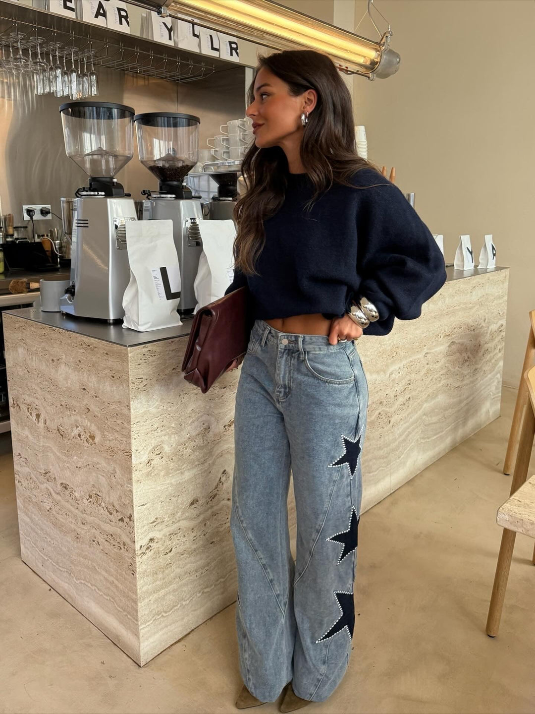 Women's light blue wide leg jeans with dark star details