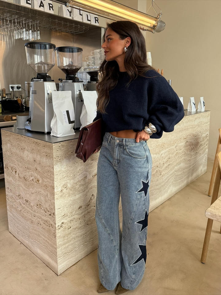 Women's light blue wide leg jeans with dark star details