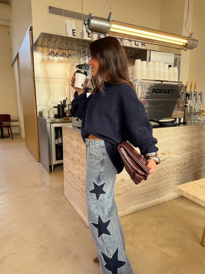 Women's light blue wide leg jeans with dark star details