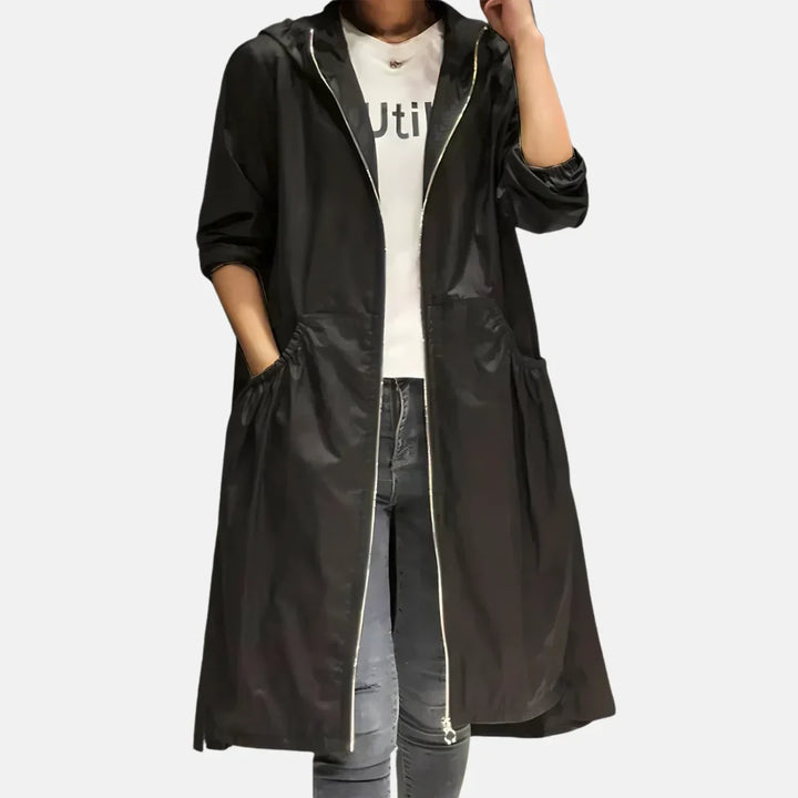 Women's hooded knee-length coat with front zipper and large angled pockets