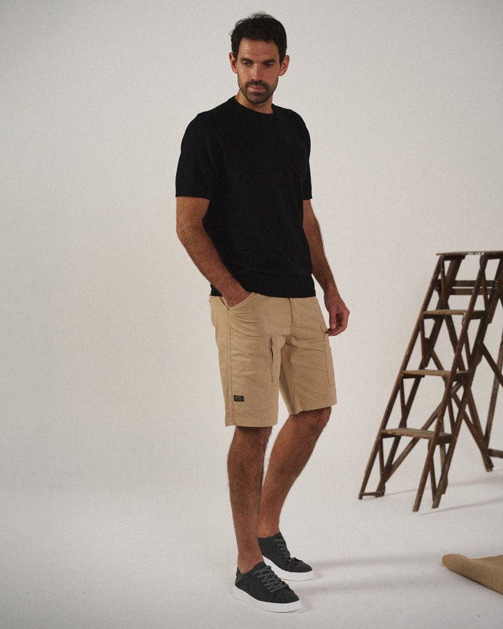 Knit slip-on shoes with round toes, pull tabs and flat black soles