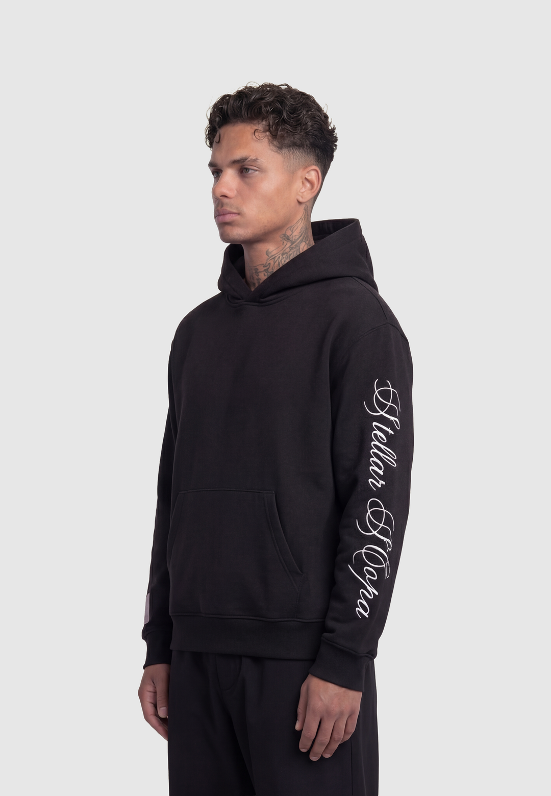 Black hooded sweatshirt with kangaroo pocket and white sleeve script
