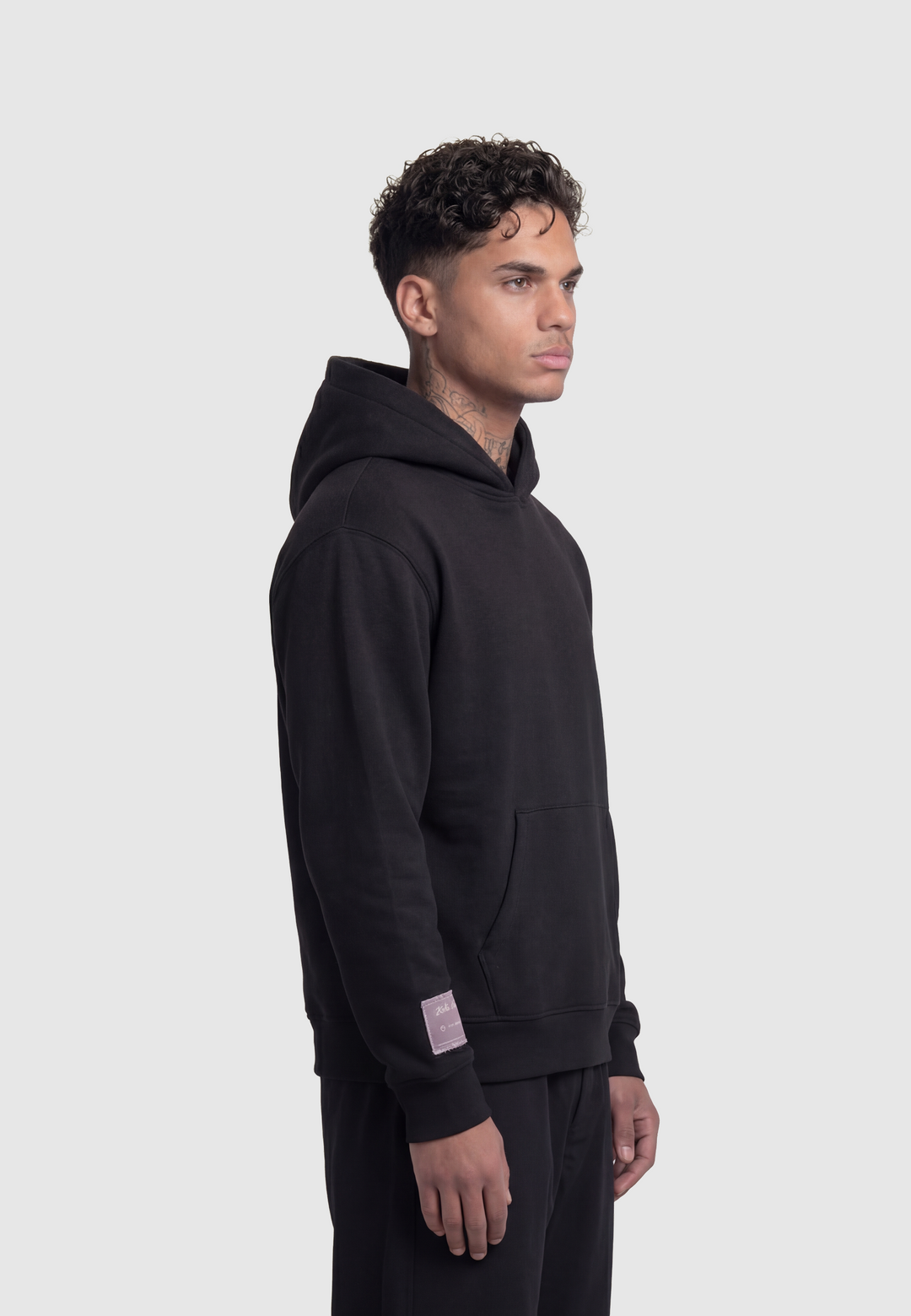 Black hooded sweatshirt with kangaroo pocket and white sleeve script