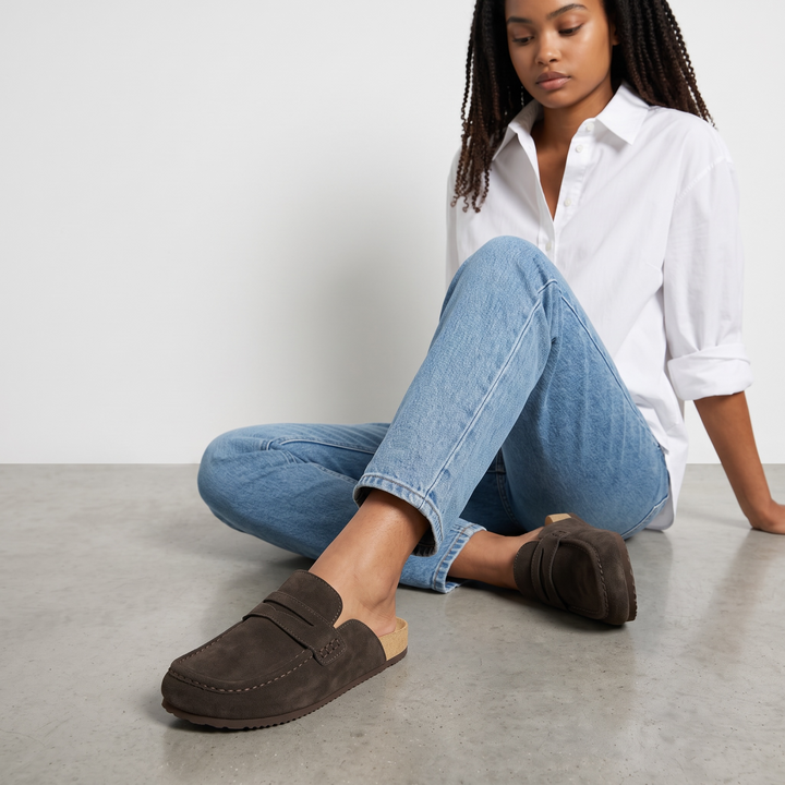 Women's brown flat loafer mule clogs with penny strap and rounded moc toe