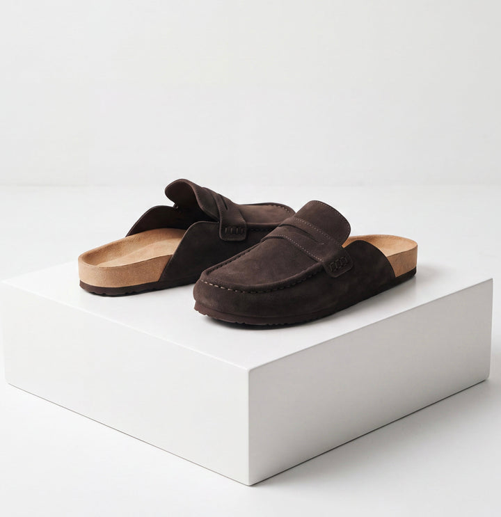 Women's brown flat loafer mule clogs with penny strap and rounded moc toe