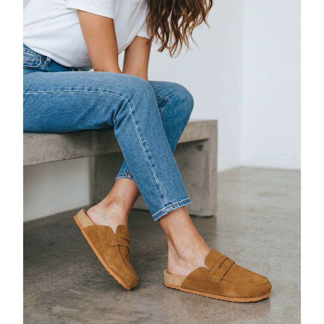 Women's brown flat loafer mule clogs with rounded moc toes and open backs