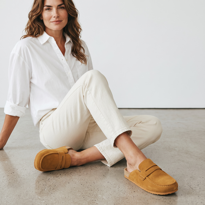 Women's brown flat loafer mule clogs with rounded moc toes and open backs