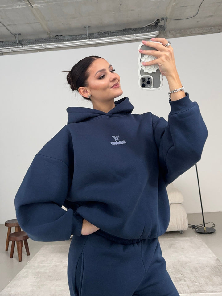 Women's navy pullover hoodie with hood, long sleeves and chest logo
