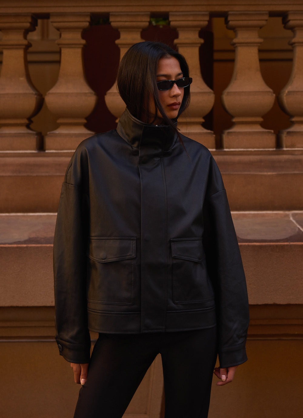 Women's black bomber jacket with mock neck, long sleeves and front flap pockets