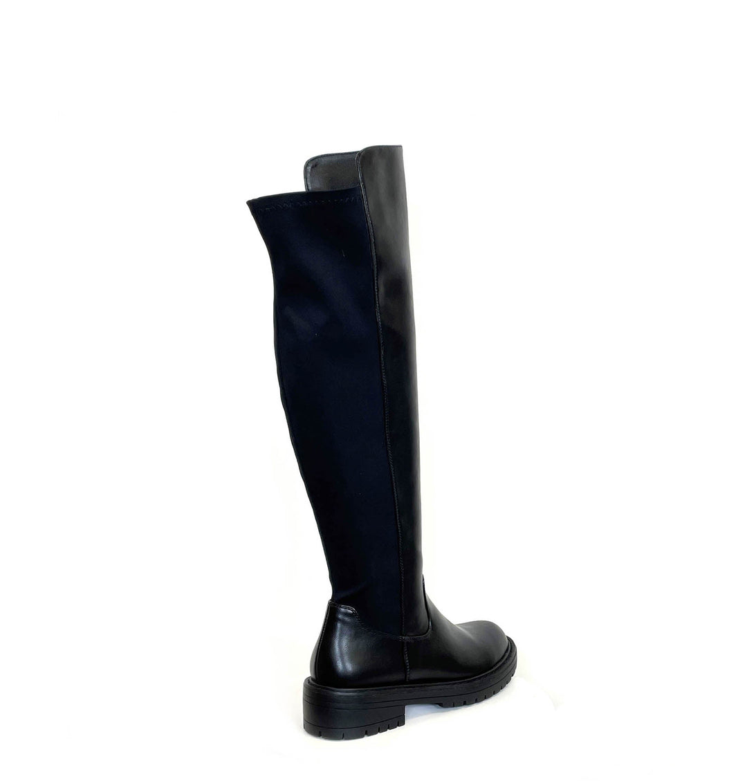 Black women's knee-high boots with round toes, side zippers, low heels and lug soles