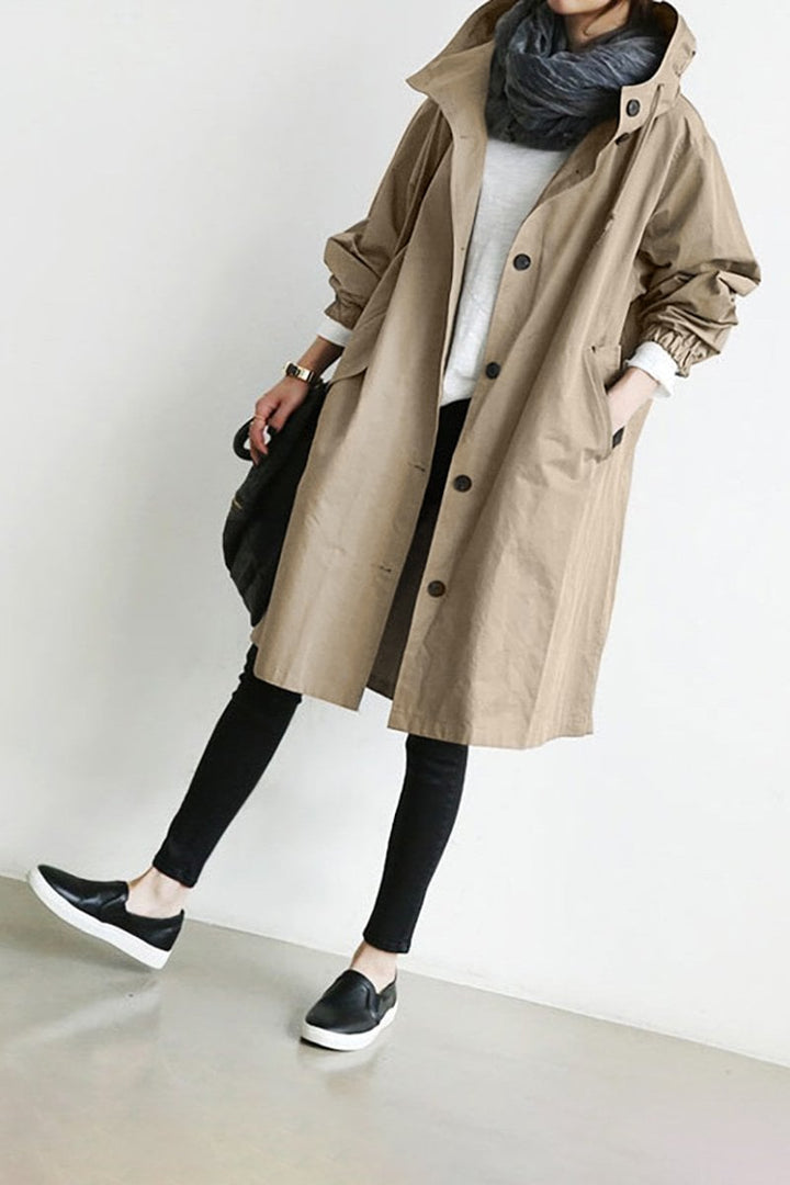 Women's long hooded trench coat with button front, elastic cuffs and side pockets