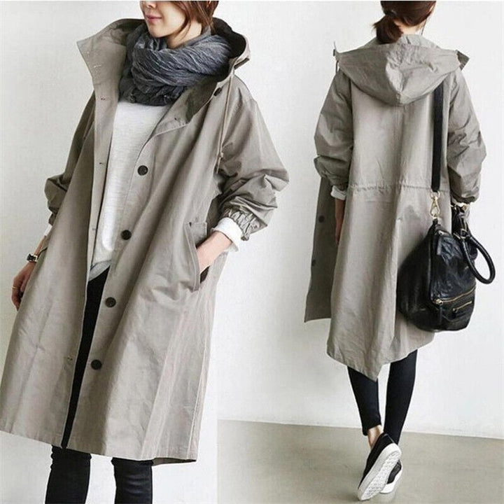Women's long hooded trench coat with button front, elastic cuffs and side pockets