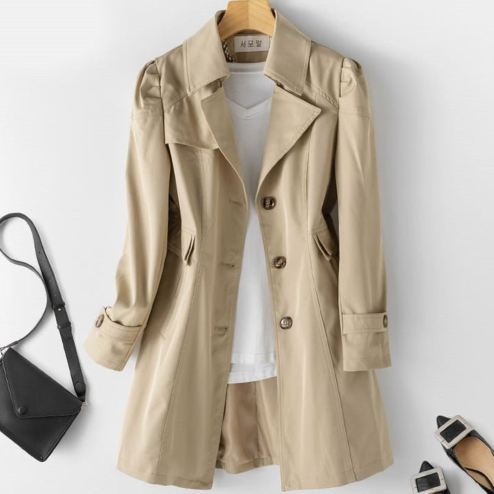 Women's tailored trench coat with notched lapels, long sleeves and buttoned cuffs