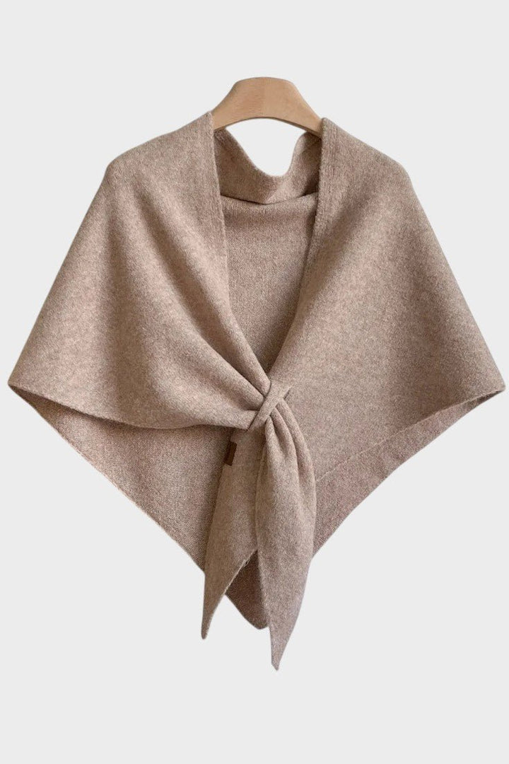Knitted triangle scarf draped over the shoulders with a tie front