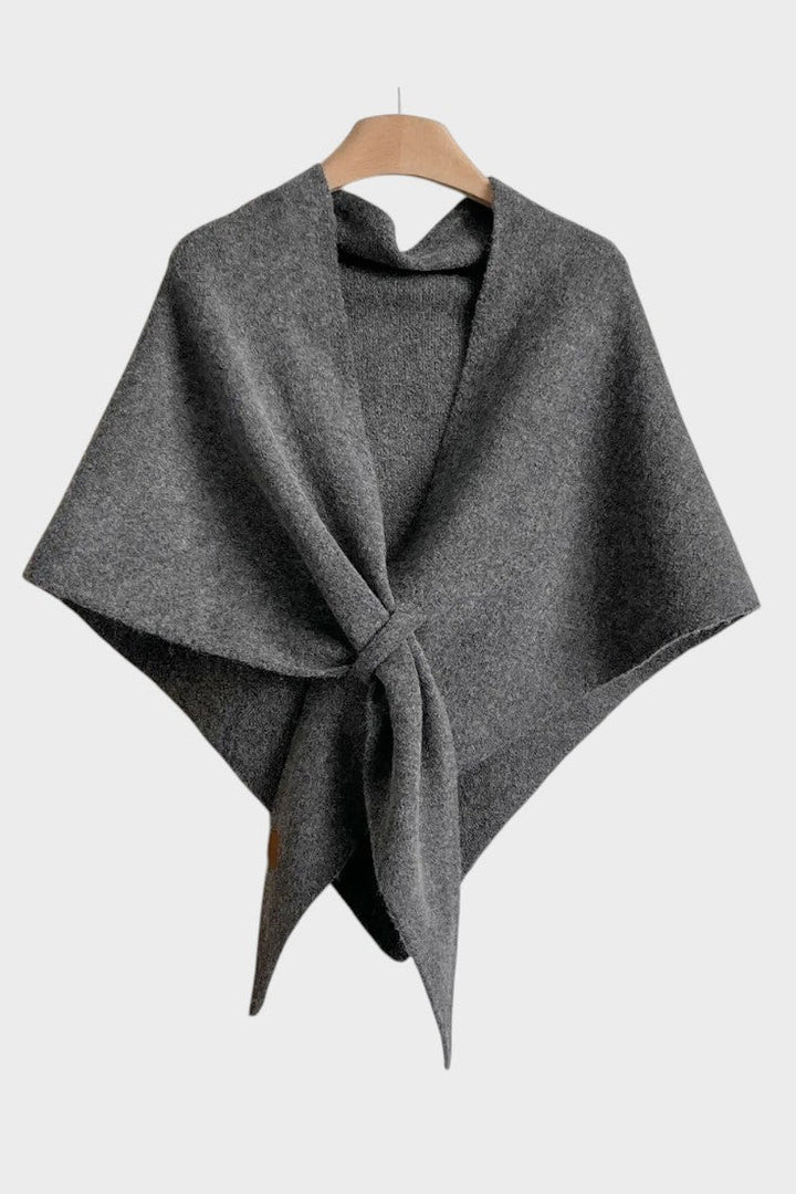 Knitted triangle scarf draped over the shoulders with a tie front