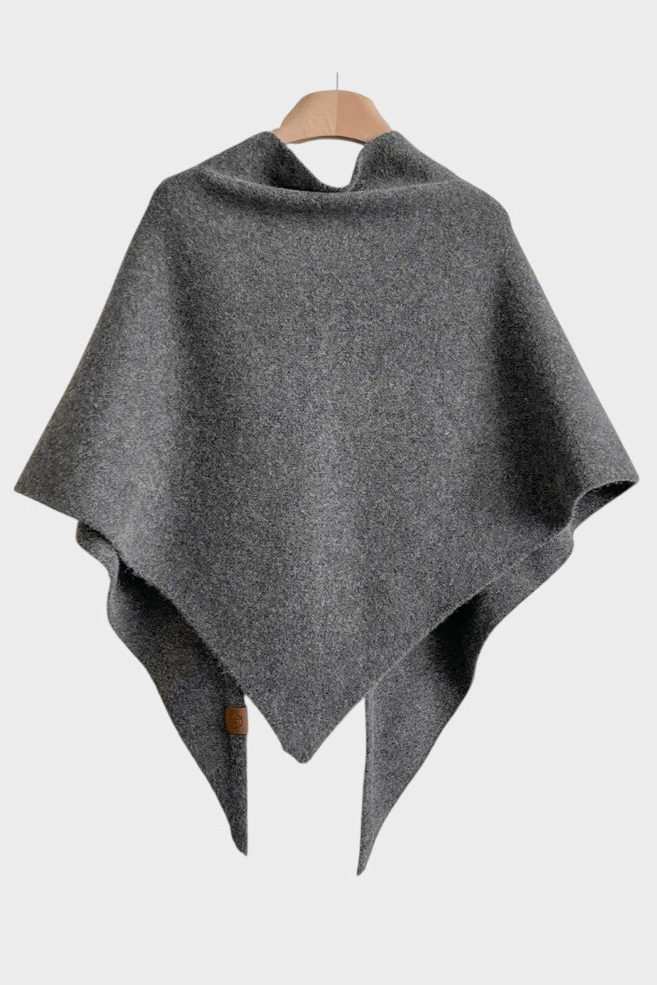 Knitted triangle scarf draped over the shoulders with a tie front