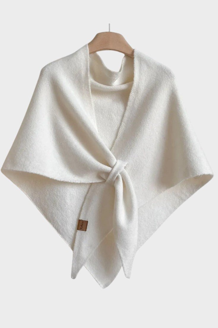 Knitted triangle scarf draped over the shoulders with a tie front