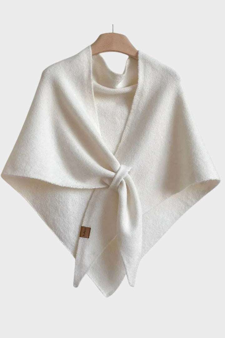 Knitted triangle scarf draped over the shoulders with a tie front