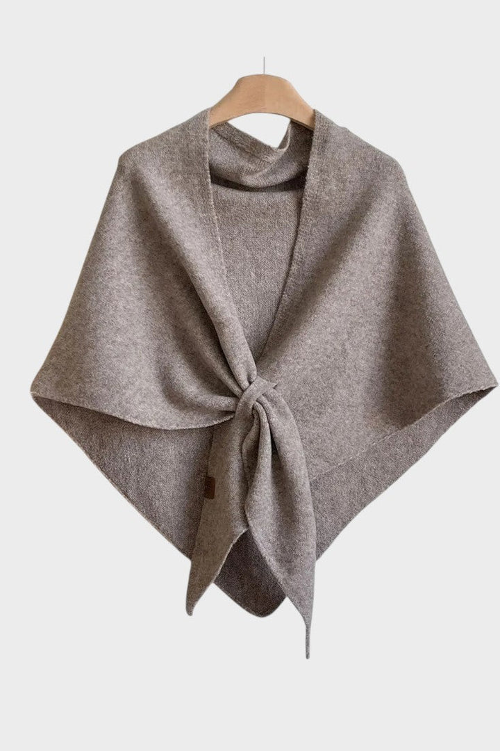 Knitted triangle scarf draped over the shoulders with a tie front