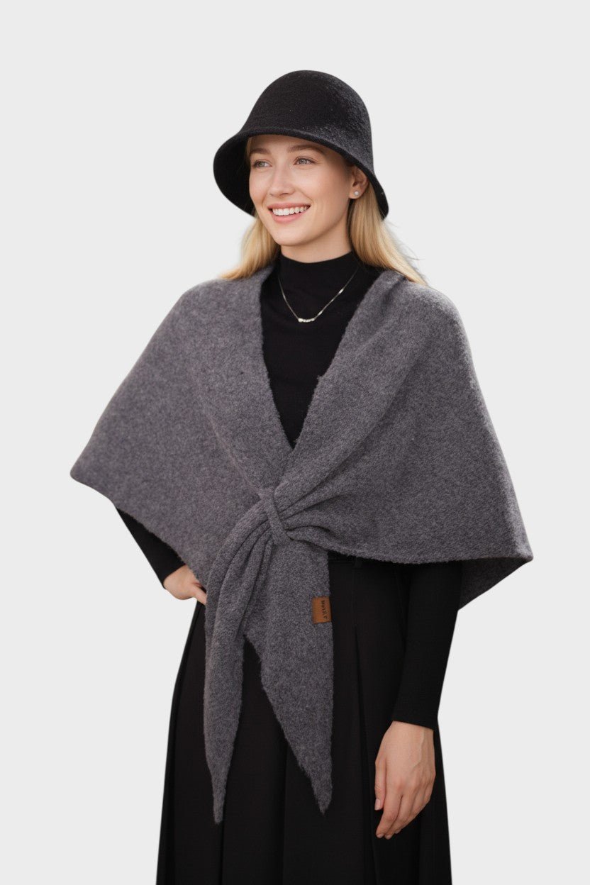 Knitted triangle scarf draped over the shoulders with a tie front