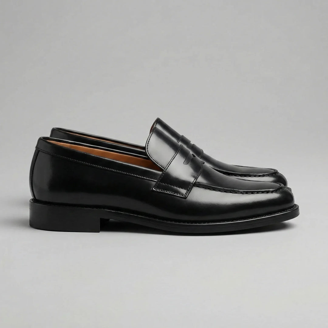 Black glossy penny loafers with moc toes and low block heels