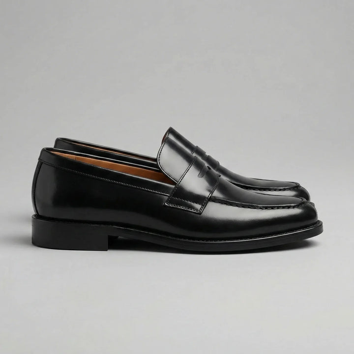 Black glossy penny loafers with moc toes and low block heels