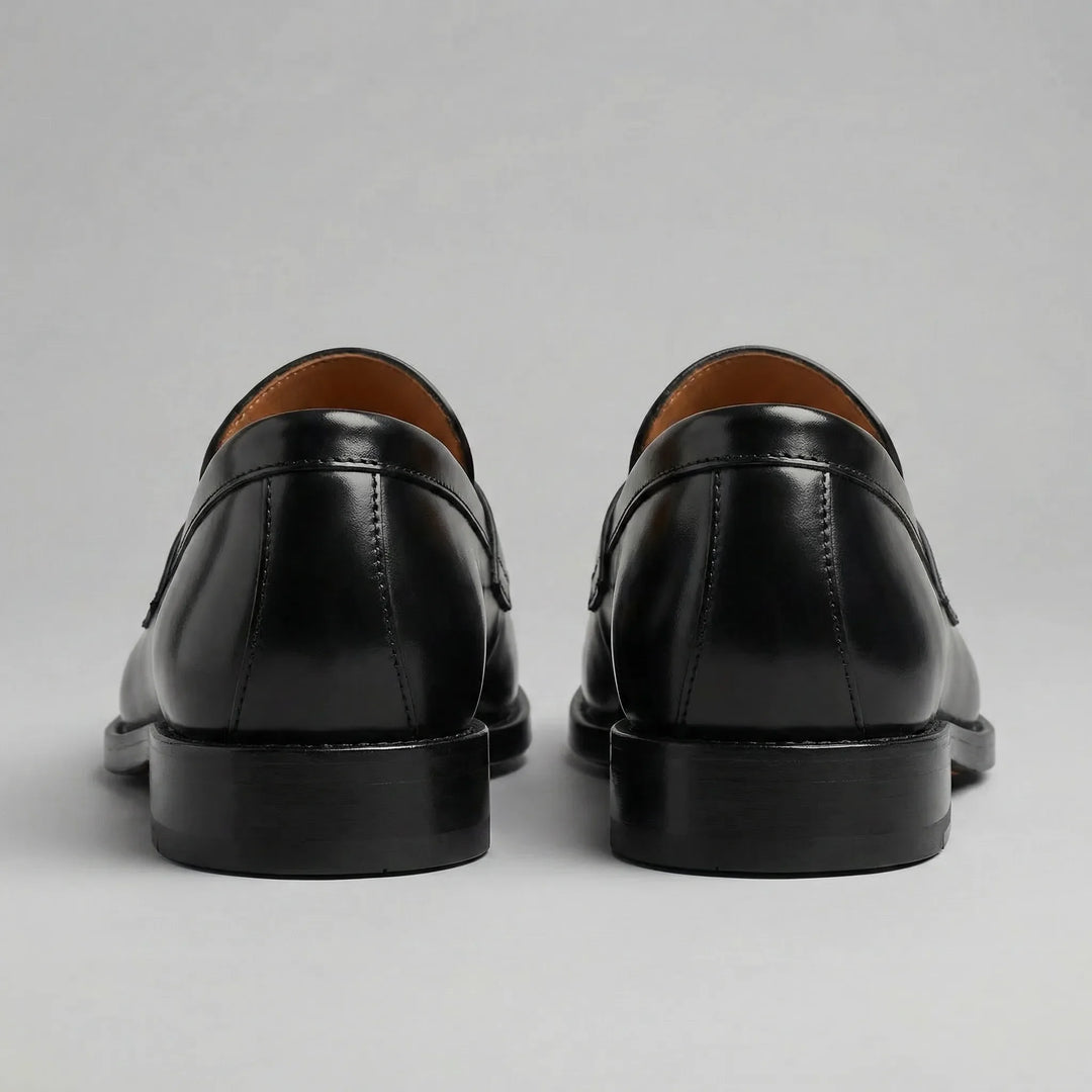 Black glossy penny loafers with moc toes and low block heels