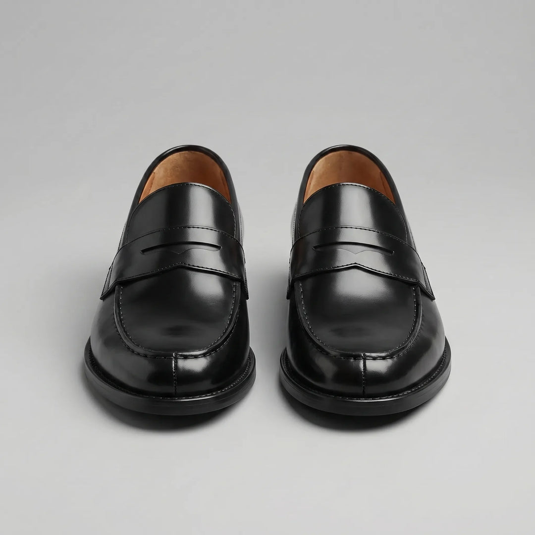 Black glossy penny loafers with moc toes and low block heels