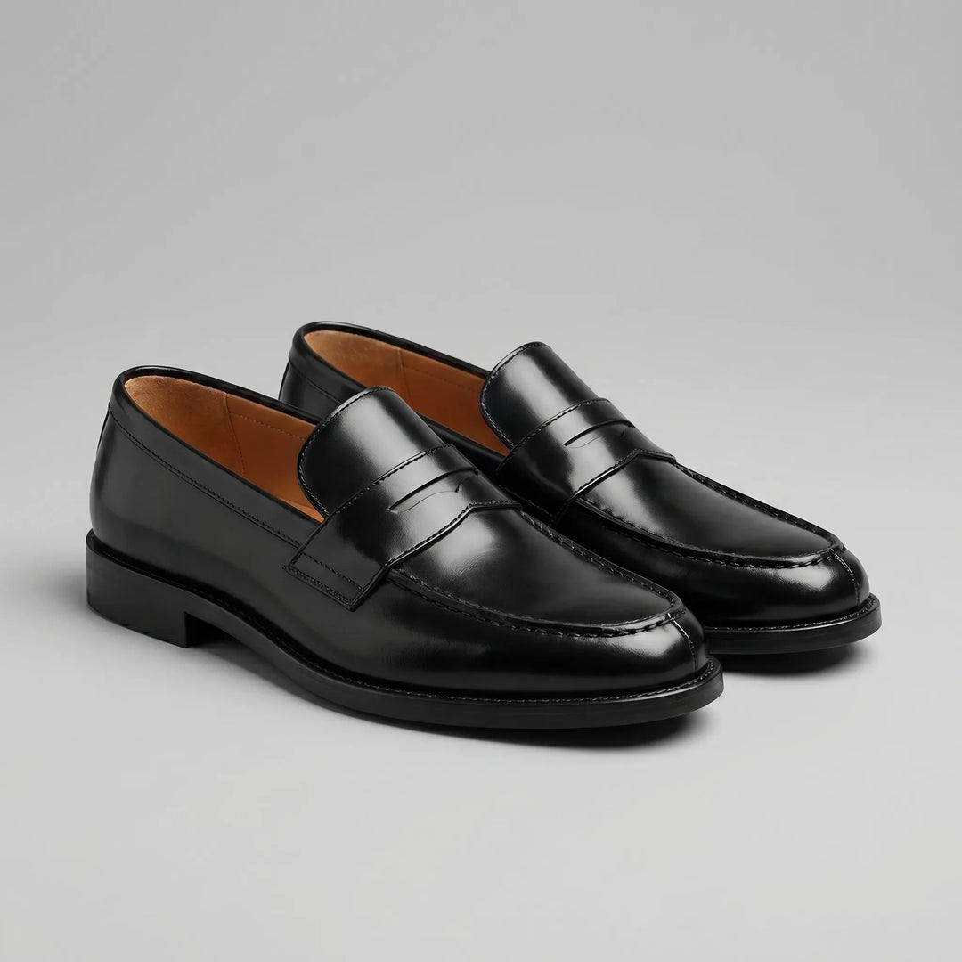 Black glossy penny loafers with moc toes and low block heels
