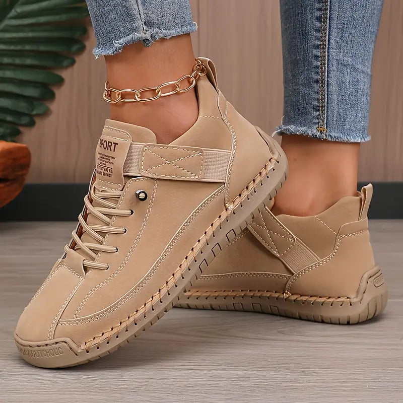 Women's high-top lace-up sneakers with stitched panels and flat textured soles