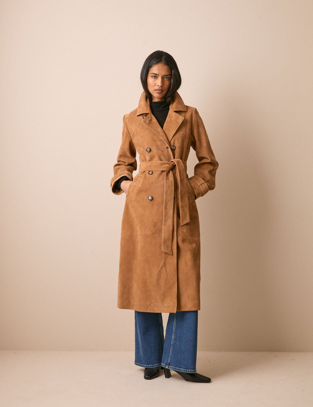 Women's brown belted trench coat with notched collar and long sleeves