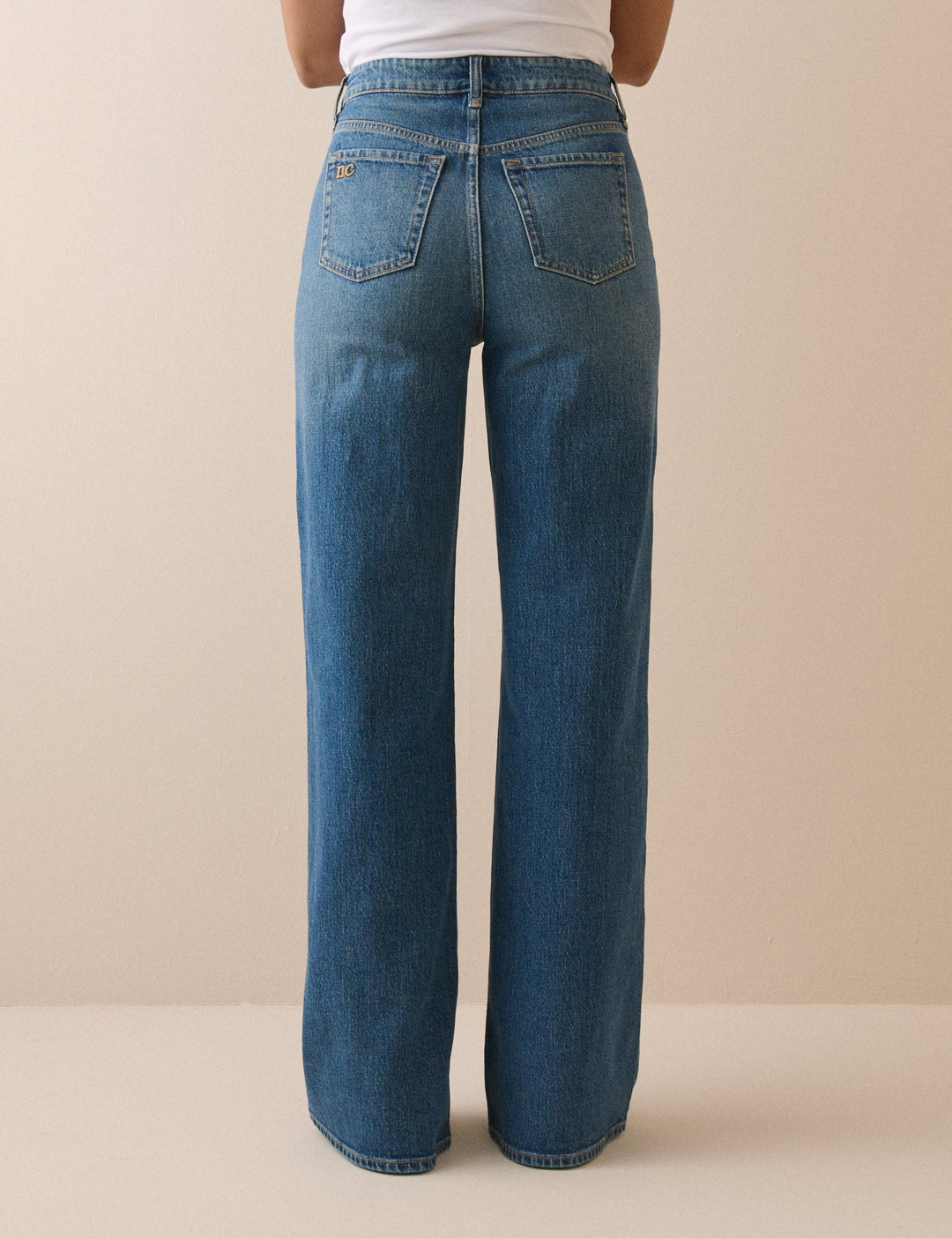 Women's mid-blue high rise wide leg jeans with full-length hems