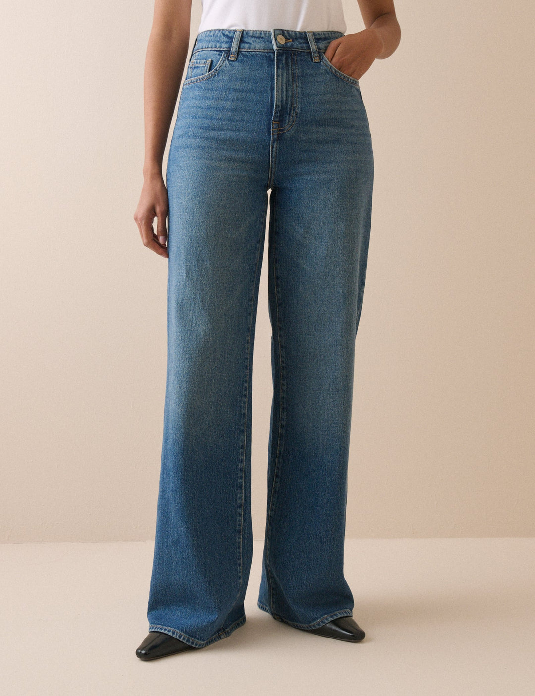 Women's mid-blue high rise wide leg jeans with full-length hems