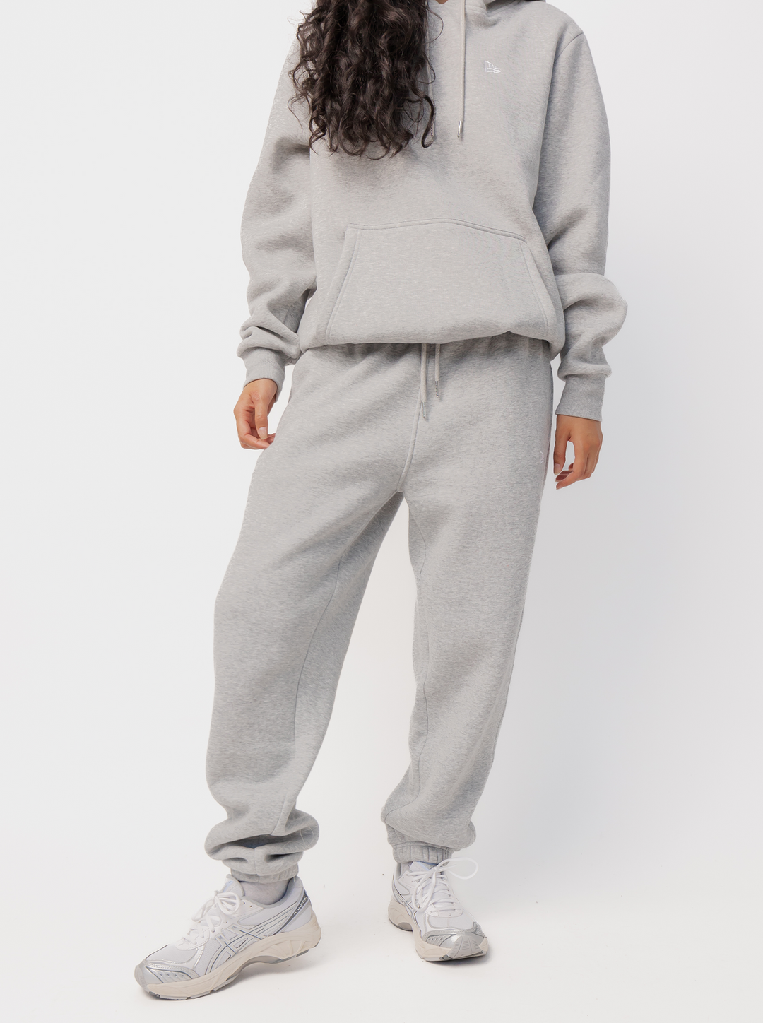 Women's grey jogger pants with logo detail, drawstring waist, side pockets and cuffed hems