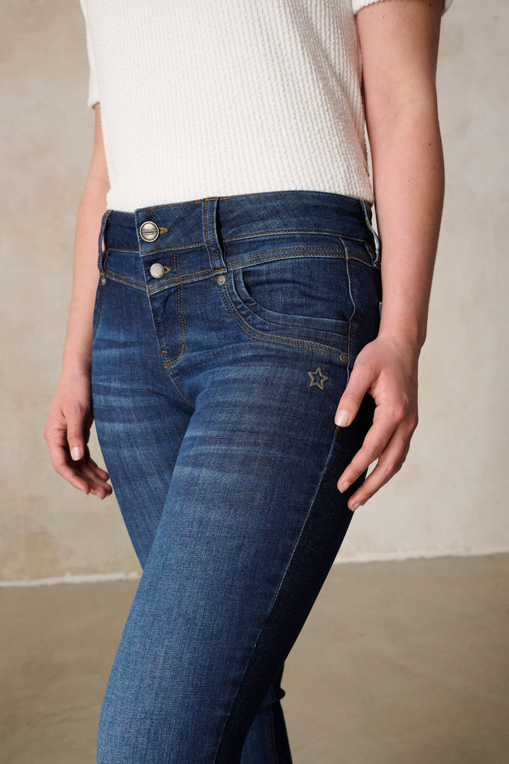 Women's dark blue slim fit jeans with mid-rise waist and button fly