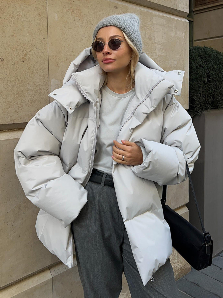Women's oversized hooded puffer jacket with quilted panels and zip front