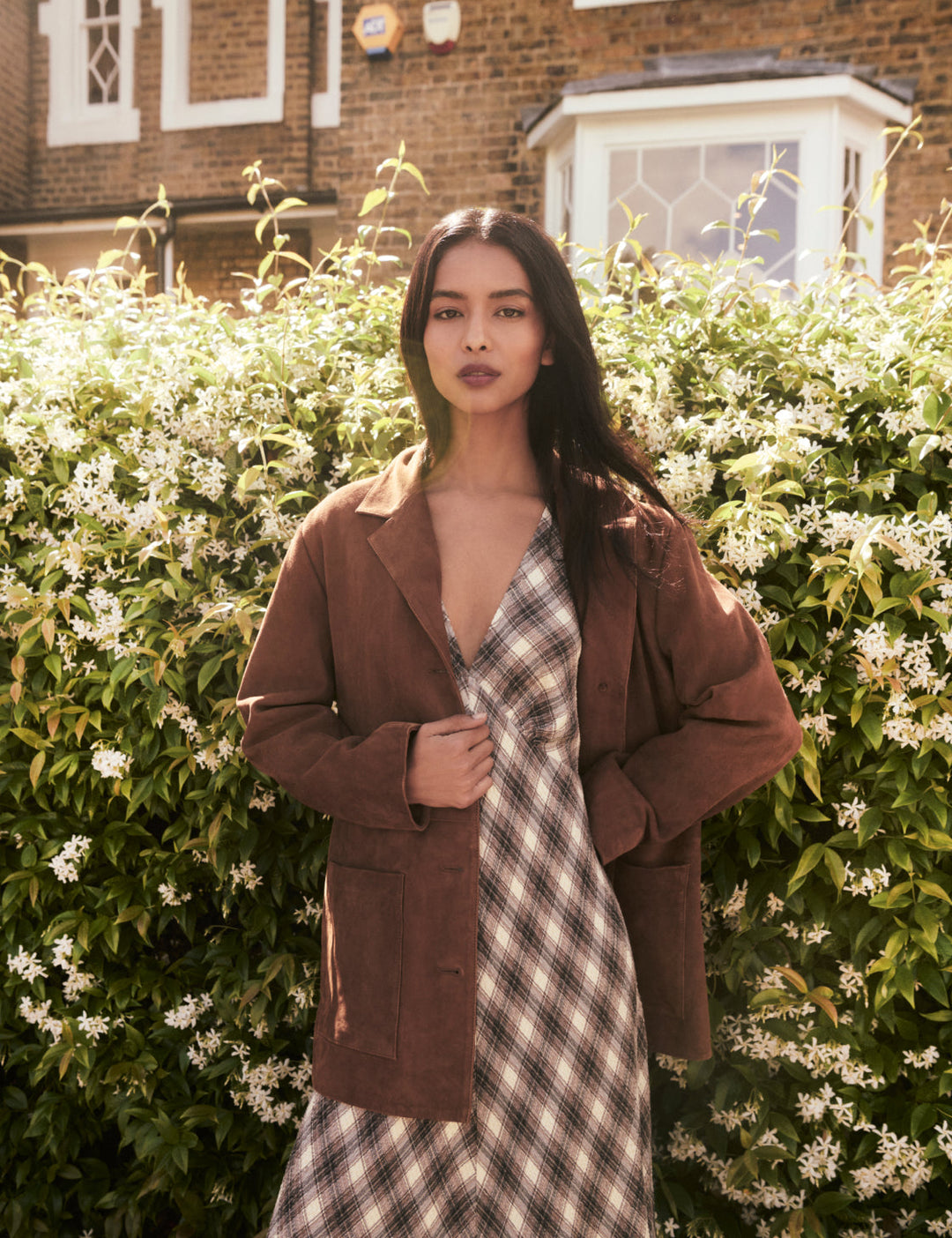 Women's brown blazer jacket with notched lapels, buttons and patch pockets