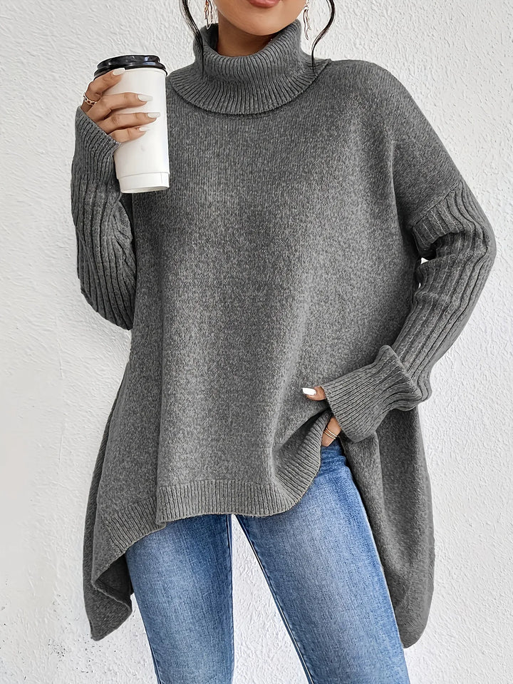 Women's oversized turtleneck sweater with asymmetric hem and side splits