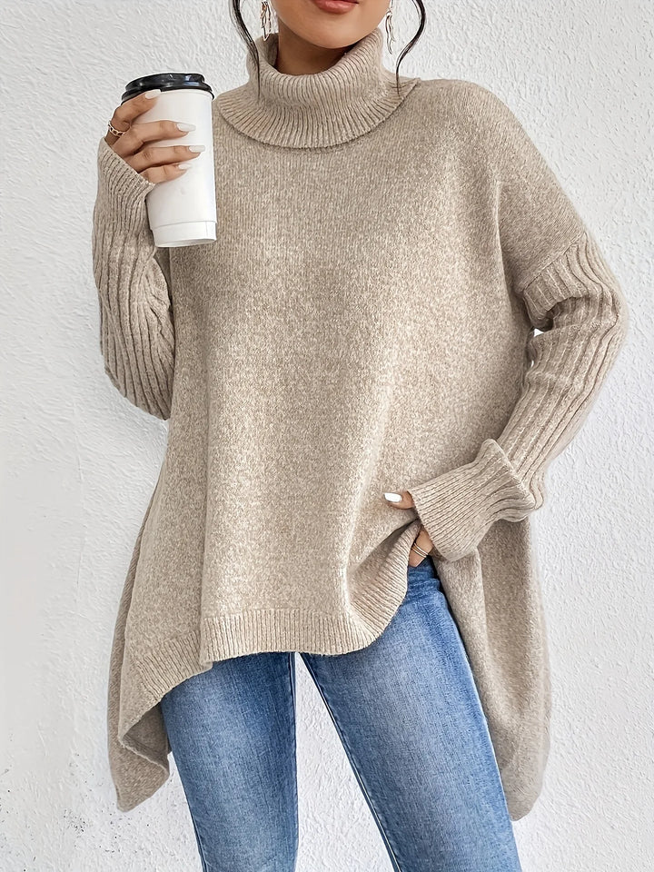 Women's oversized turtleneck sweater with asymmetric hem and side splits