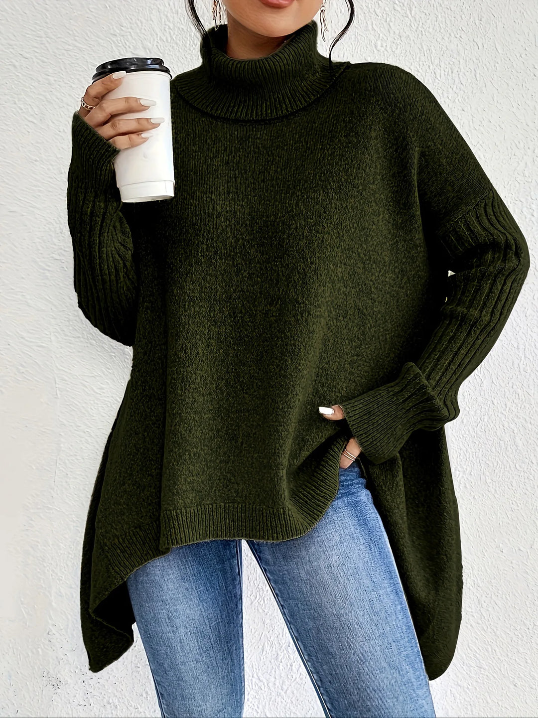 Women's oversized turtleneck sweater with asymmetric hem and side splits