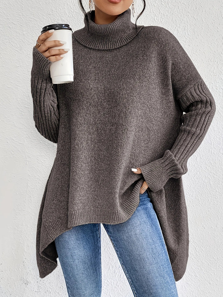 Women's oversized turtleneck sweater with asymmetric hem and side splits