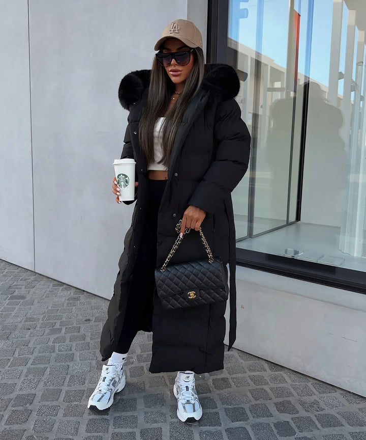 Women's black quilted puffer coat with hood, belt and long calf-length cut