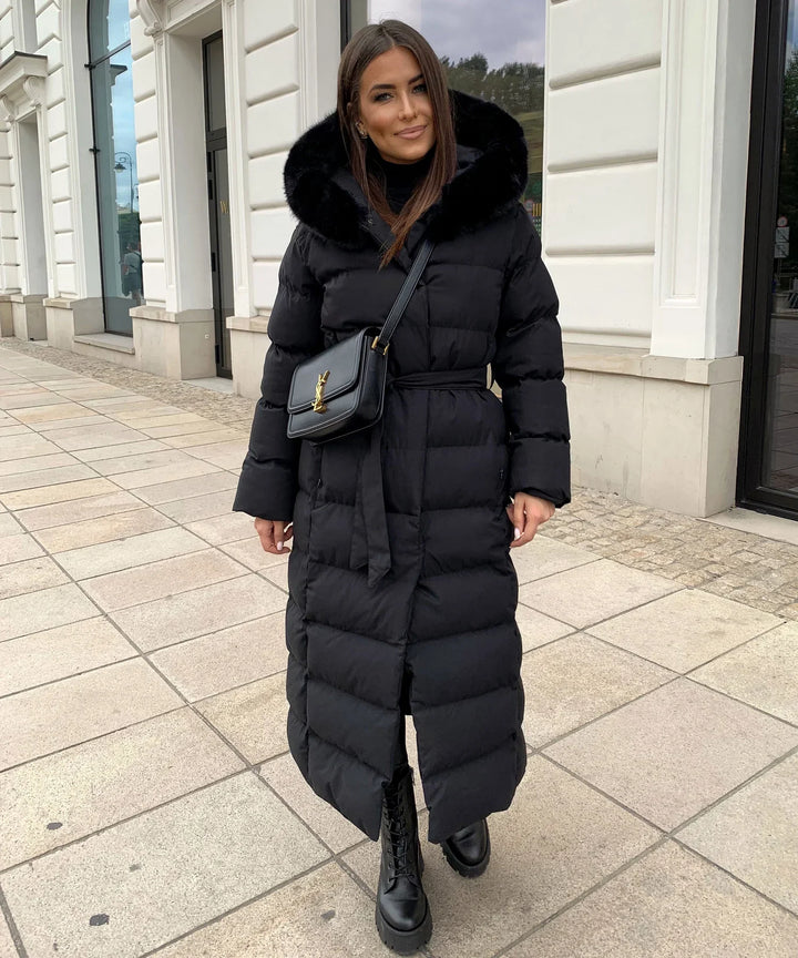 Women's black quilted puffer coat with hood, belt and long calf-length cut