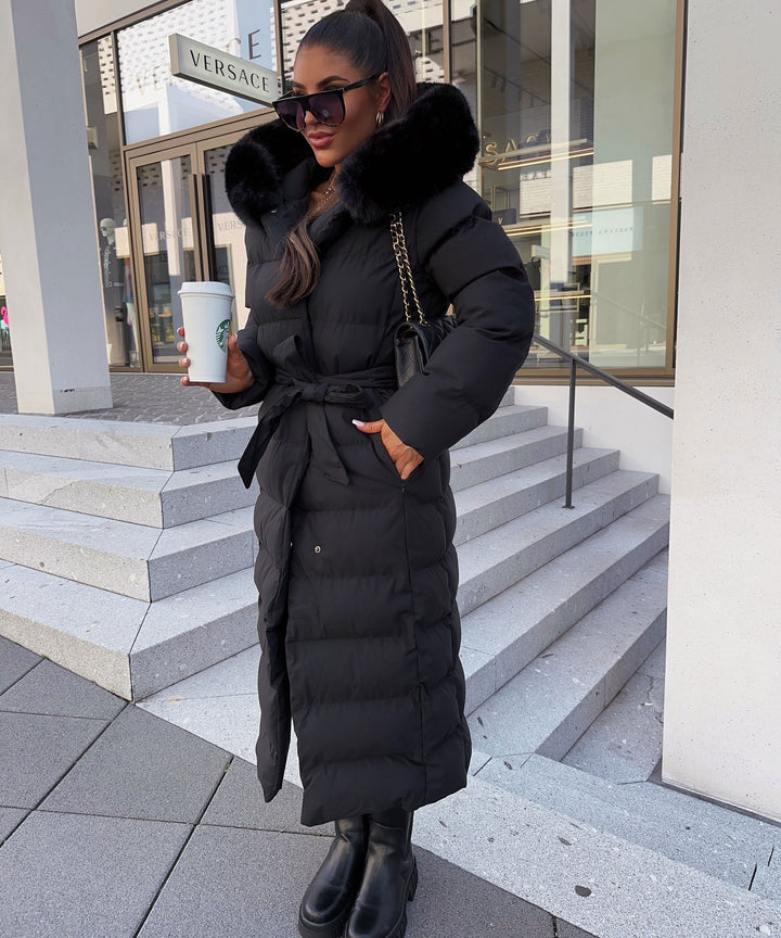Women's black quilted puffer coat with hood, belt and long calf-length cut