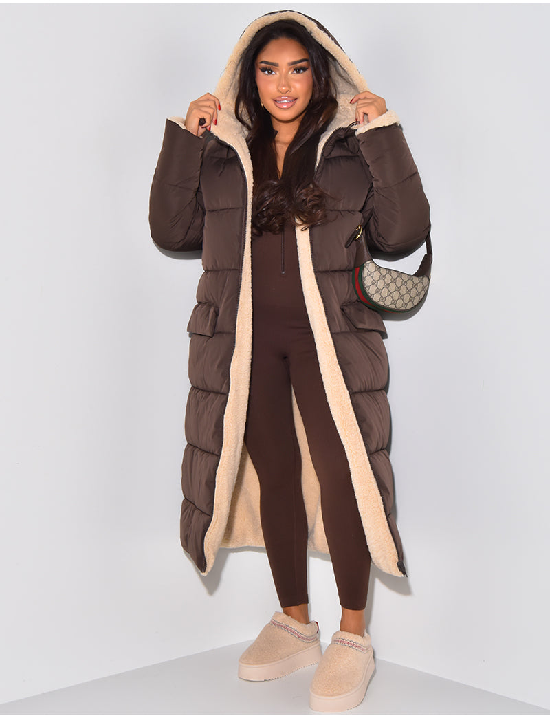 Women's long reversible hooded puffer coat shown with quilted and textured sides