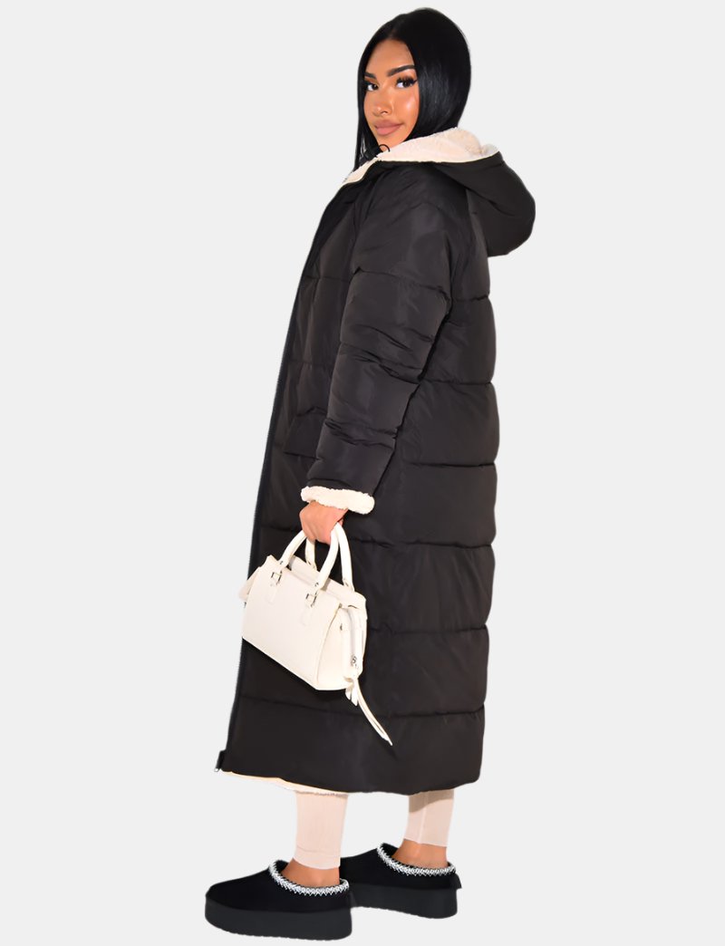 Women's long reversible hooded puffer coat shown with quilted and textured sides