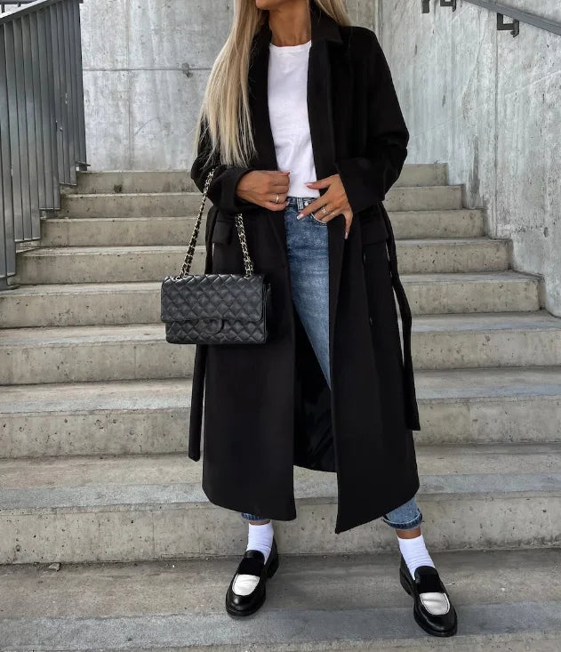 Women's long double-breasted structured coat with notched lapels, tie belt and flap pockets