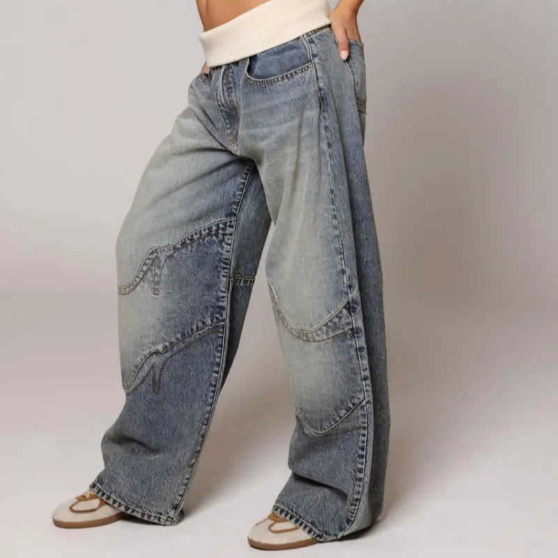 Women's blue wide-leg jeans with ribbed waistband and curved stitched panels
